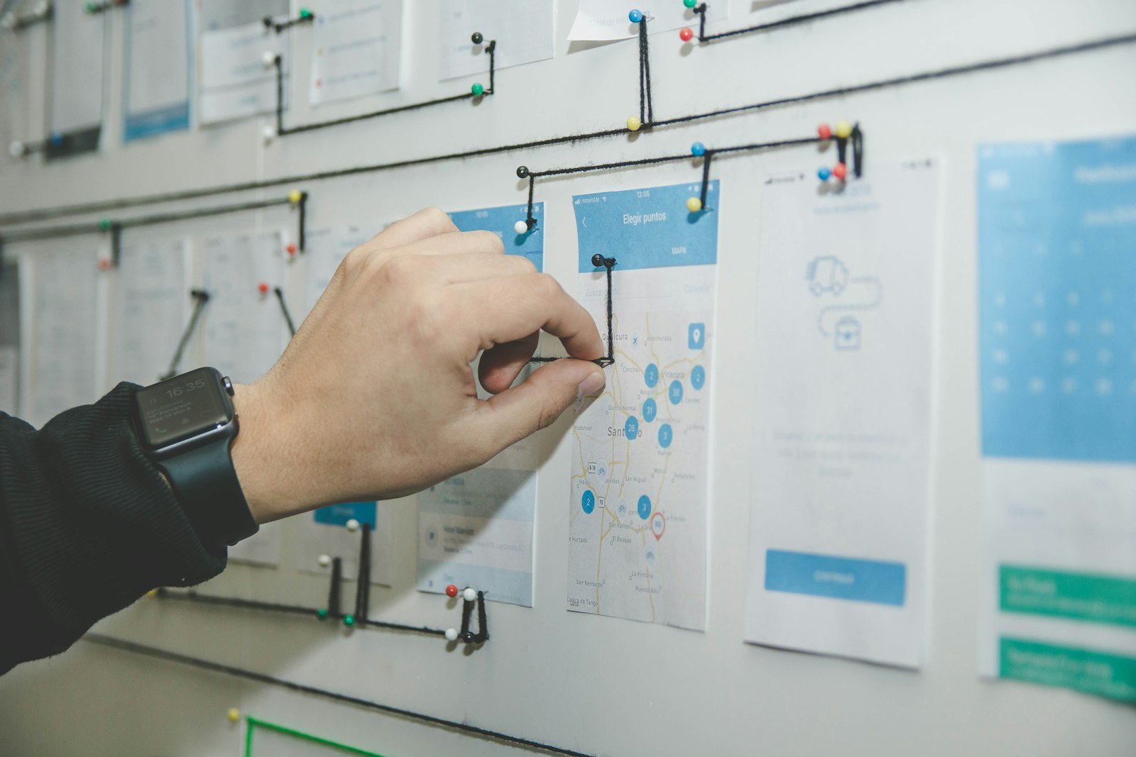 Wireframes pinned to a planning wall